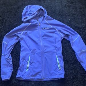 Purple Columbia windbreaker with hood and zipper pockets.
